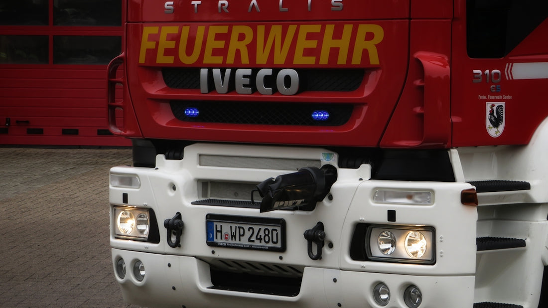 a red and white truck parked in front of a building