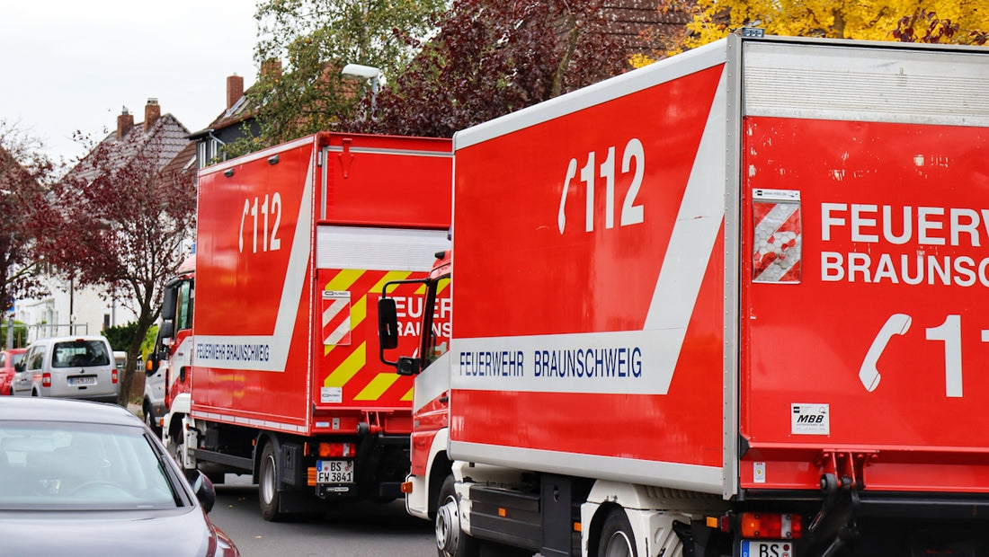 a red delivery truck driving down a street